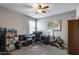 Bedroom featuring ceiling fan, window, and office space with comfortable seating at 3515 N Brooklyn Dr, Buckeye, AZ 85396