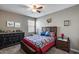 A bedroom with ceiling fan, carpet flooring, and bed with a decorative quilt at 3515 N Brooklyn Dr, Buckeye, AZ 85396