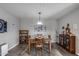 Inviting dining room featuring a wooden table, stylish decor, and modern lighting at 3515 N Brooklyn Dr, Buckeye, AZ 85396