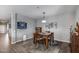 Bright dining room with wooden table and chair set, complemented by gray walls and modern decor at 3515 N Brooklyn Dr, Buckeye, AZ 85396