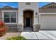 Inviting entryway with a covered porch and decorative stone accents at 3515 N Brooklyn Dr, Buckeye, AZ 85396