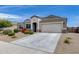 Charming single-story home with desert landscaping and a two-car garage at 3515 N Brooklyn Dr, Buckeye, AZ 85396