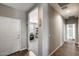 Hallway with wood-look tile flooring leading to a carpeted room at 3515 N Brooklyn Dr, Buckeye, AZ 85396