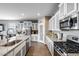 Modern kitchen featuring granite countertops, stainless steel appliances, and plentiful cabinet storage at 3515 N Brooklyn Dr, Buckeye, AZ 85396