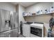 A laundry room featuring new stainless steel appliances and storage space at 3515 N Brooklyn Dr, Buckeye, AZ 85396