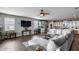 Open concept living room with a ceiling fan and updated kitchen in the background at 3515 N Brooklyn Dr, Buckeye, AZ 85396