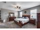 Cozy main bedroom with a ceiling fan, a large mirror, and comfortable furnishings at 3515 N Brooklyn Dr, Buckeye, AZ 85396