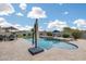 A luxurious backyard pool featuring a waterfall and comfortable seating at 3515 N Brooklyn Dr, Buckeye, AZ 85396