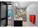 Open bathroom view featuring modern sink, granite countertop, dark cabinets, a glass-walled shower, and bedroom access at 37221 N Holiday Ln, Carefree, AZ 85377