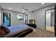Cozy bedroom featuring neutral walls, a TV, a ceiling fan, and a calming view through the windows to the outside at 37221 N Holiday Ln, Carefree, AZ 85377