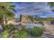 Picturesque community pool area with rock waterfall features and inviting desert landscaping at 37221 N Holiday Ln, Carefree, AZ 85377