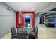 Modern dining room featuring a glass table, gray walls, and a pop of red color accent wall for a bold and stylish look at 37221 N Holiday Ln, Carefree, AZ 85377