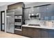 Stylish kitchen featuring stainless steel appliances, modern cabinetry, and sleek countertops at 37221 N Holiday Ln, Carefree, AZ 85377