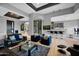 Elegant open-concept living room with bar, modern furniture, and stylish decor at 37221 N Holiday Ln, Carefree, AZ 85377