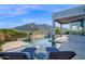 Luxury home with a stunning pool area, featuring lounge chairs and mountain views at 37221 N Holiday Ln, Carefree, AZ 85377