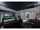 A home theater room with plush leather seating, a large projection screen, and sophisticated lighting for an immersive experience at 37221 N Holiday Ln, Carefree, AZ 85377