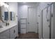 Clean bathroom featuring dual sinks, framed mirrors and a tiled walk-in shower at 3911 S 78Th Ln, Phoenix, AZ 85043