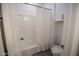 Clean bathroom featuring a white shower, toilet, and upper cabinets for storage at 3911 S 78Th Ln, Phoenix, AZ 85043
