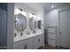 Modern bathroom featuring dual sinks with framed mirrors, a vanity with storage and a walk-in shower at 3911 S 78Th Ln, Phoenix, AZ 85043