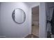 Hallway with gray flooring leading to an adjacent bedroom with ceiling fan at 3911 S 78Th Ln, Phoenix, AZ 85043
