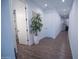 Inviting hallway with tile floors, recessed lighting, and a decorative potted plant at 3911 S 78Th Ln, Phoenix, AZ 85043