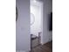 Hallway with dark tile floors and neutral wall featuring a safety gate at 3911 S 78Th Ln, Phoenix, AZ 85043