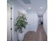 Long hallway with warm wood-look tile flooring, recessed lighting, and neutral paint at 3911 S 78Th Ln, Phoenix, AZ 85043