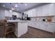 Bright kitchen featuring white cabinets, a spacious island, and modern appliances at 3911 S 78Th Ln, Phoenix, AZ 85043