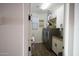 Well-lit laundry room featuring modern washer and dryer, storage, and tile floors at 3911 S 78Th Ln, Phoenix, AZ 85043