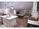Open concept kitchen, living, and dining area with modern light fixtures at 3911 S 78Th Ln, Phoenix, AZ 85043