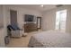 Well-lit bedroom with a ceiling fan, tv and ensuite bath offering a serene retreat at 3911 S 78Th Ln, Phoenix, AZ 85043