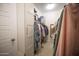Bright walk-in closet featuring ample storage with rods and shelves at 3911 S 78Th Ln, Phoenix, AZ 85043