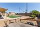 Large backyard featuring artificial lawn, pavers, string lights, and mature landscaping, perfect for outdoor enjoyment at 4117 W Whispering Wind Dr, Glendale, AZ 85310