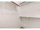 Walk-in closet with white shelves and hanging rods for ample storage at 4117 W Whispering Wind Dr, Glendale, AZ 85310