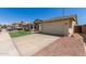 Charming single-story home featuring an attached two-car garage and desert landscaping at 4117 W Whispering Wind Dr, Glendale, AZ 85310