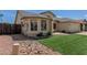 Charming single-story home featuring a well-manicured lawn and desert landscaping at 4117 W Whispering Wind Dr, Glendale, AZ 85310