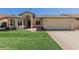 Charming single-story home featuring a well-manicured lawn and an attached two-car garage at 4117 W Whispering Wind Dr, Glendale, AZ 85310