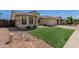 Charming single-story home featuring a well-manicured lawn and desert landscaping at 4117 W Whispering Wind Dr, Glendale, AZ 85310