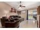 Inviting living room featuring tile floors and a sliding glass door to the backyard at 4117 W Whispering Wind Dr, Glendale, AZ 85310