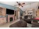 Comfortable living room featuring a fireplace and ample space for entertaining at 4117 W Whispering Wind Dr, Glendale, AZ 85310