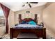 Main bedroom with a ceiling fan, ample natural light, and a comfortable king bed at 4117 W Whispering Wind Dr, Glendale, AZ 85310