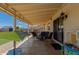 Covered patio with wicker furniture, a Little Tikes play kitchen, and string lights at 4117 W Whispering Wind Dr, Glendale, AZ 85310