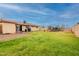 This backyard features a grassy lawn, a patio area and string lights overhead at 4160 W Granada Rd, Phoenix, AZ 85009