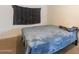 Bedroom featuring a blue blanket and a dark gray wall decoration above the bed at 4160 W Granada Rd, Phoenix, AZ 85009
