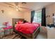 Cozy bedroom with a ceiling fan, window, and vanity table with storage at 4160 W Granada Rd, Phoenix, AZ 85009