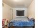 Smaller bedroom with a blue blanket and a small wall-mounted shelf above the bed at 4160 W Granada Rd, Phoenix, AZ 85009