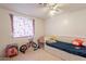 Bright bedroom with storage bed, window, ceiling fan, bicycle, and scooter at 4160 W Granada Rd, Phoenix, AZ 85009