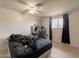 Bright bedroom features a ceiling fan, window, and vanity with a lit mirror at 4160 W Granada Rd, Phoenix, AZ 85009