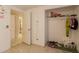 Bedroom with a view into the bathroom and an open closet with hanging clothes at 4160 W Granada Rd, Phoenix, AZ 85009