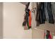 A closet with hung shirts, pants and a small shelving unit at 4160 W Granada Rd, Phoenix, AZ 85009